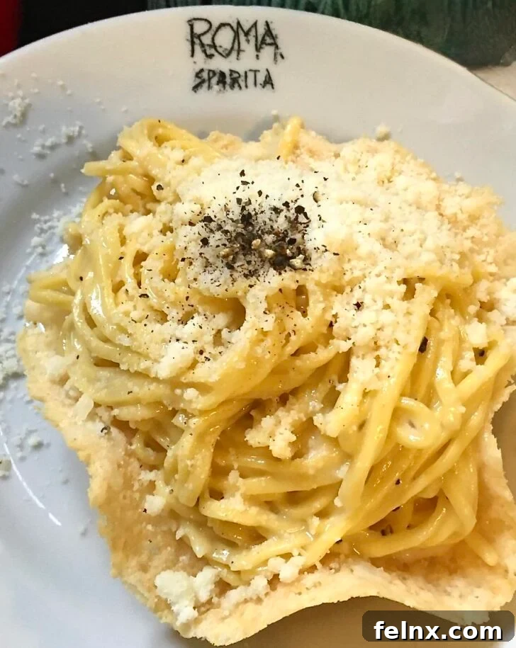 Traditional Roman Cacio e Pepe pasta served in a crispy cheese bowl