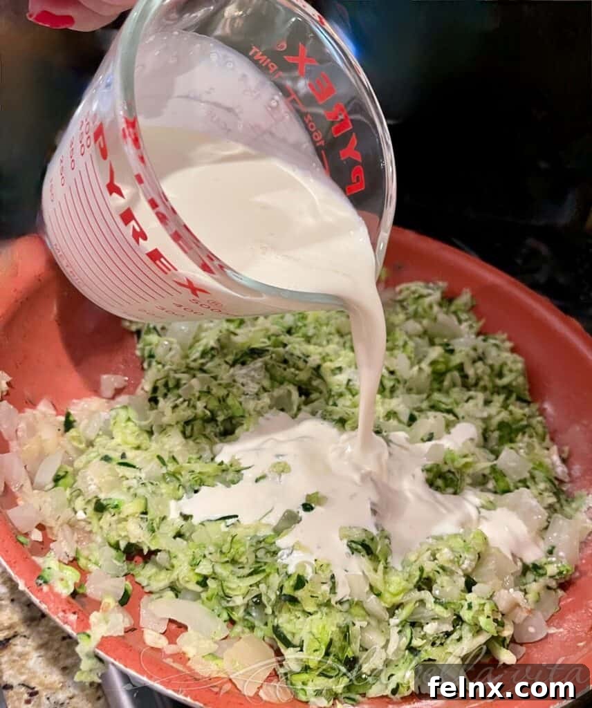 Adding cream to the zucchini mixture