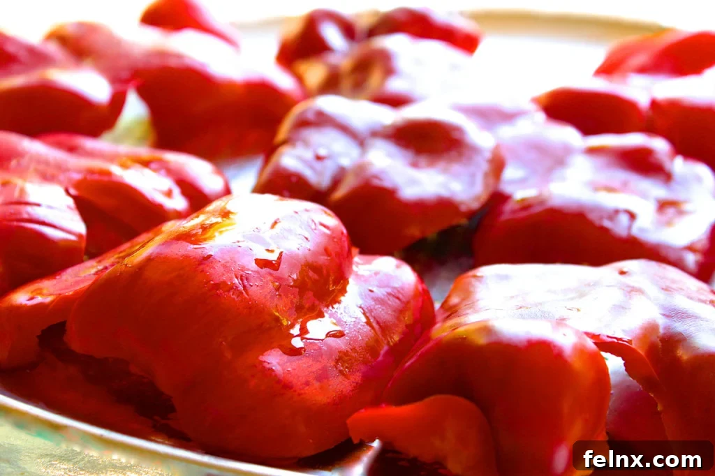 Peppers laid out flat on a pizza pan for roasting