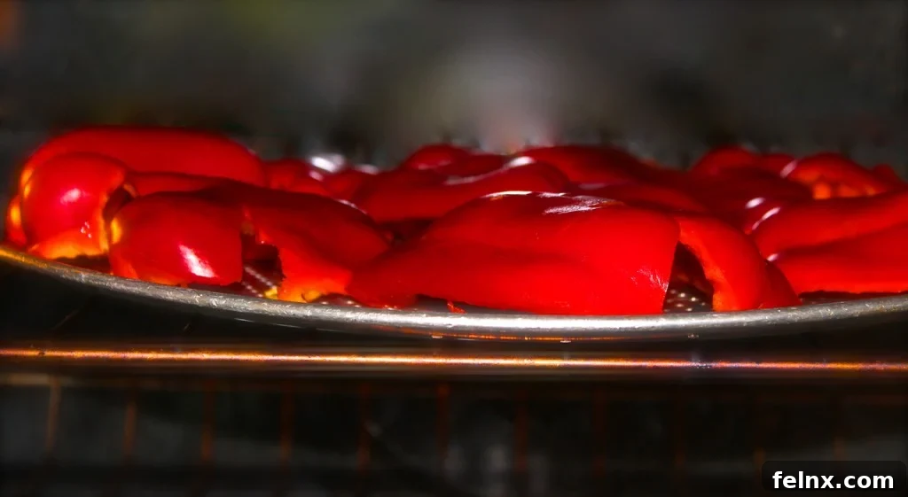 Removing charred peppers from the oven