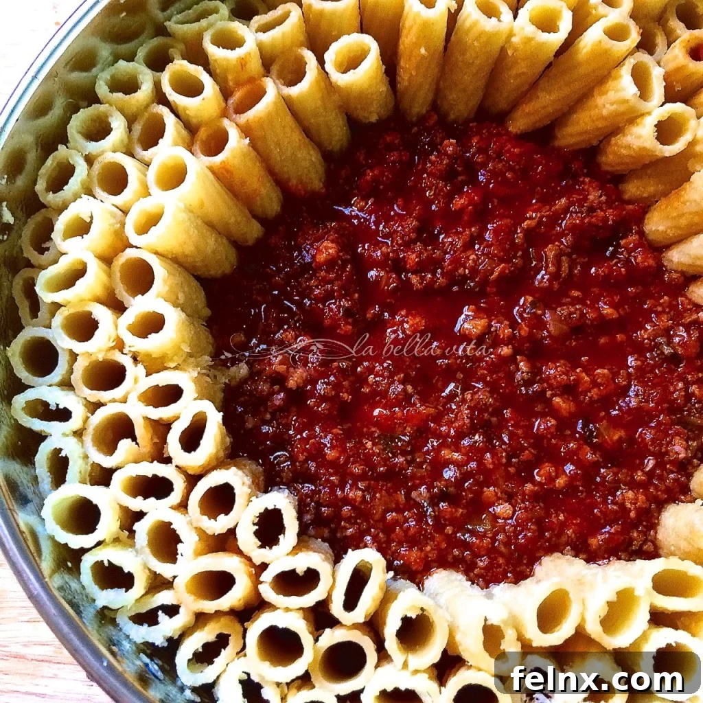 Place rigatoni upright around the pan