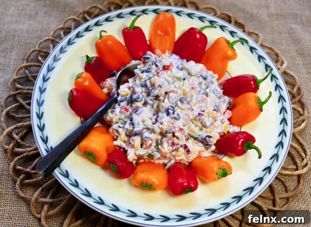 Cheesy Fiesta Corn Dip served with mini peppers