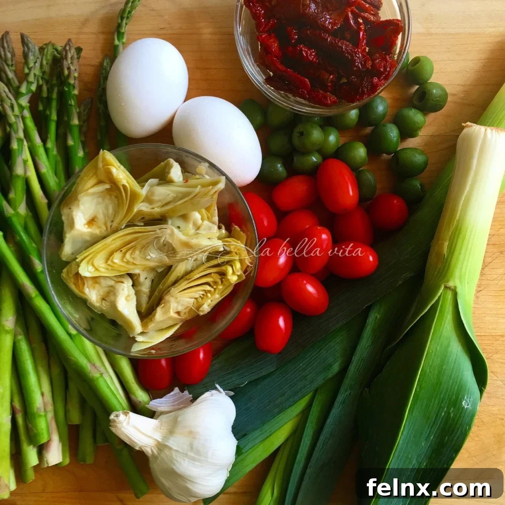 Vegetables spread on a baking sheet before roasting