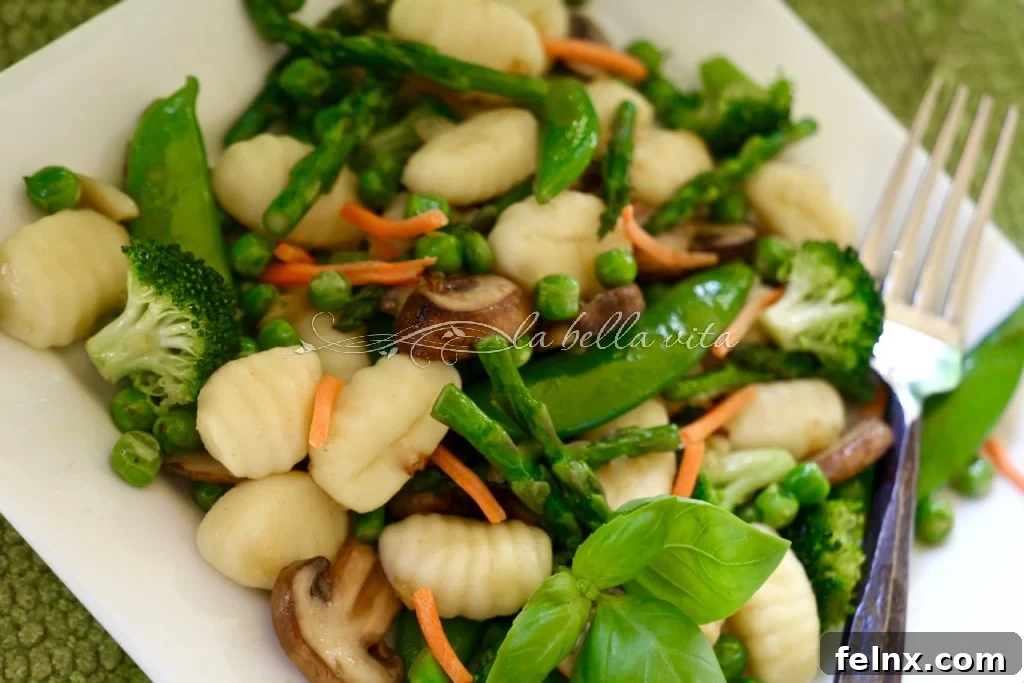 Cooking gnocchi in a skillet with vegetables