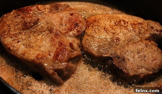 Sautéing pork chops in a pan