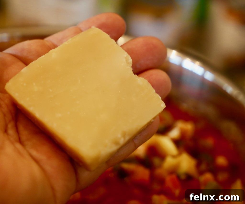 The secret Parmesan rind being added