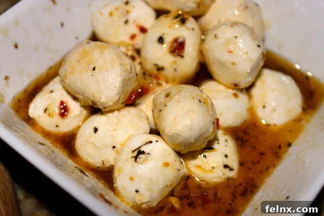Small balls of fresh marinated mozzarella cheese ready for topping