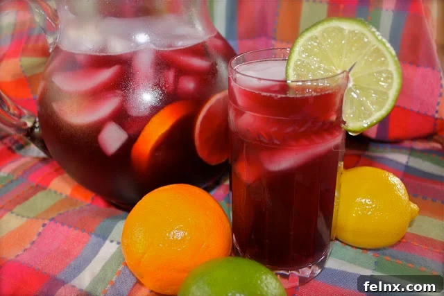 Glass of Sangria with cinnamon stick and orange