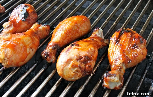 Drumsticks cooking on an outdoor grill