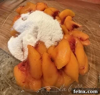 Adding sugar to sliced peaches