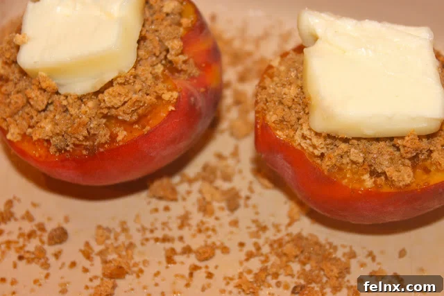 Stuffed peaches with butter on top before broiling