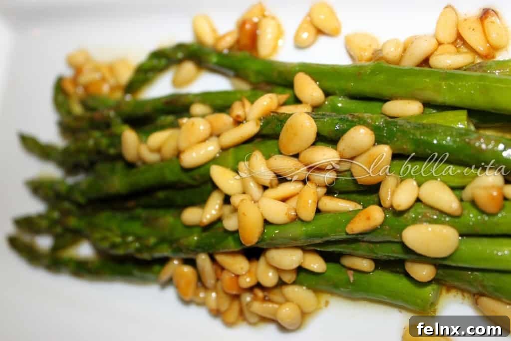 Close up of brown butter asparagus with toasted pine nuts