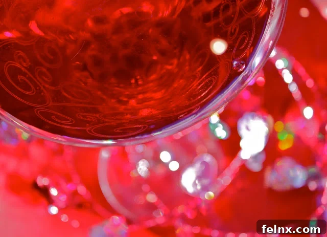Two vibrant red Pomatini cocktails served in elegant glasses garnished with pomegranate seeds