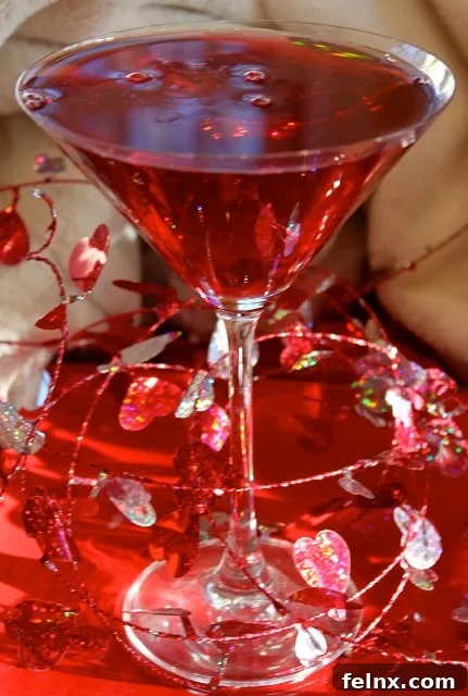 A close-up of a Pomatini showing pomegranate seeds resting at the bottom of the glass