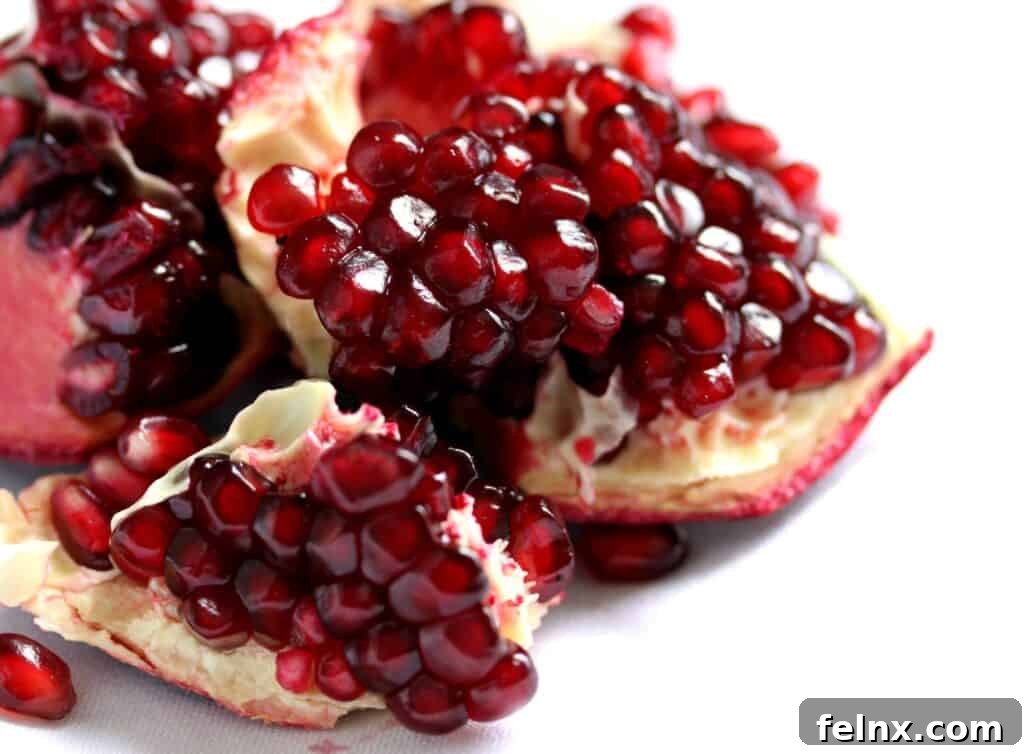 Fresh pomegranates cut open to reveal the juicy red arils