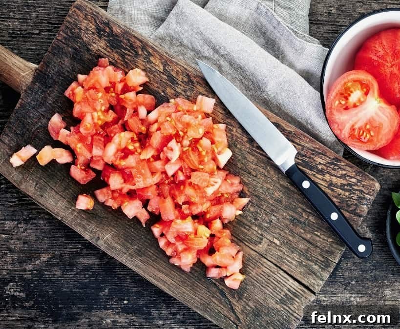 Adding chopped Roma tomatoes to the mix