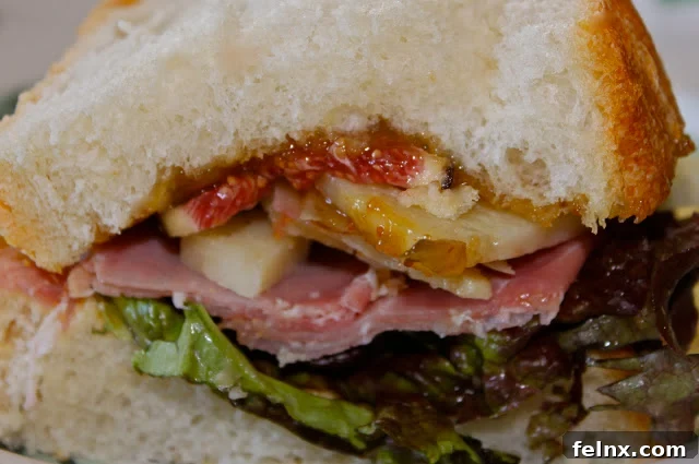 Close-up of fresh figs and prosciutto layers in a sandwich