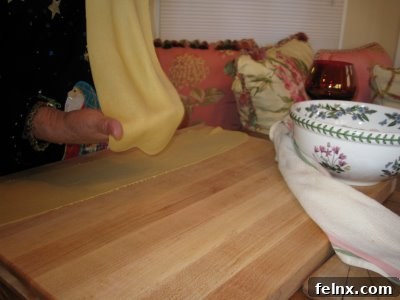 Handmade pasta dough being prepared for tortellini