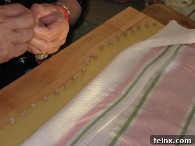 Using a damp towel to keep pasta dough moist during the filling process