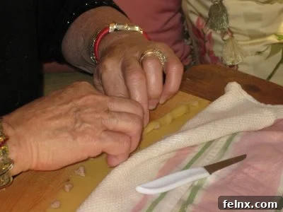 Folding the pasta dough over the filling balls