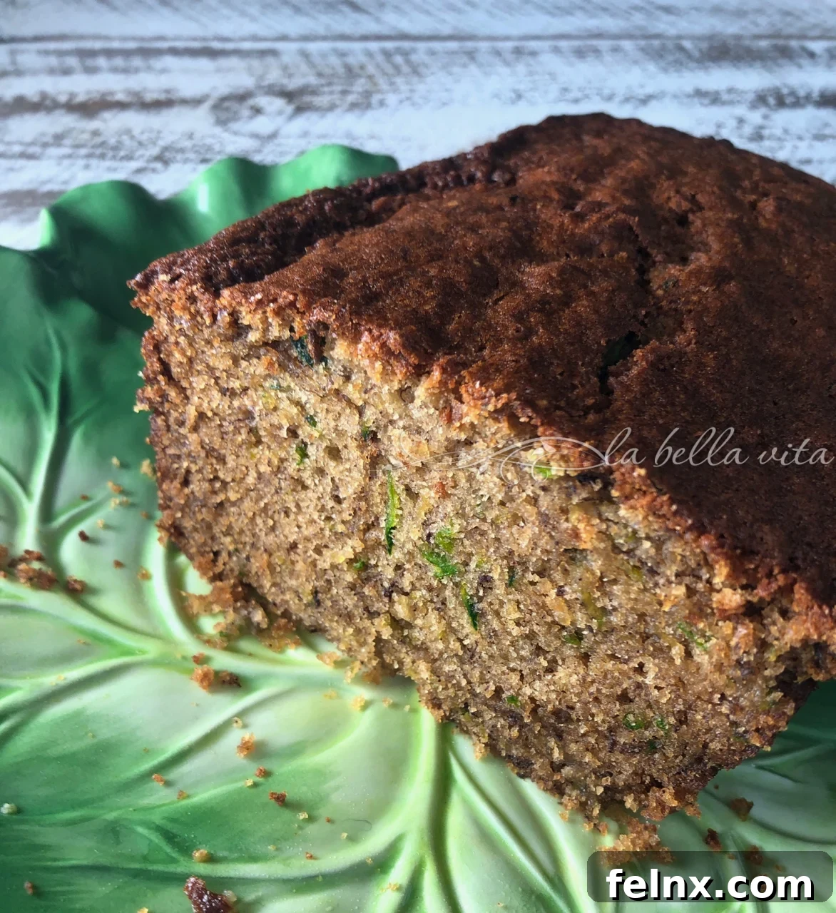Sliced Zucchini Banana Bread on a green plate