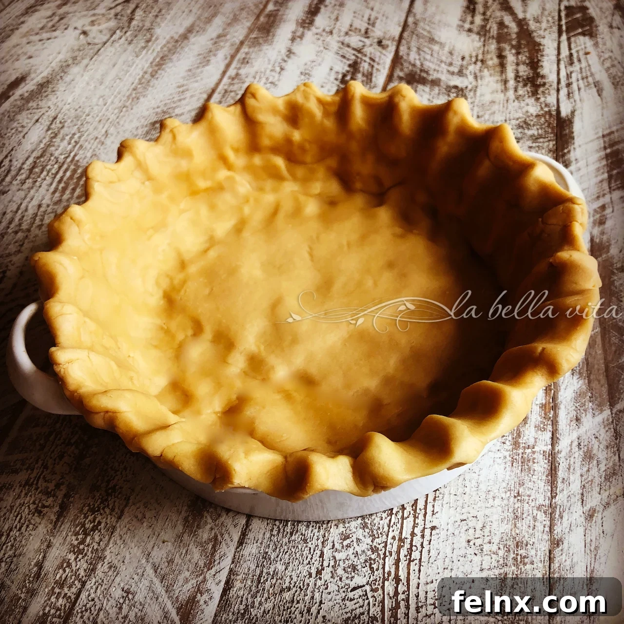 Pie dough placed in a deep dish baking pan