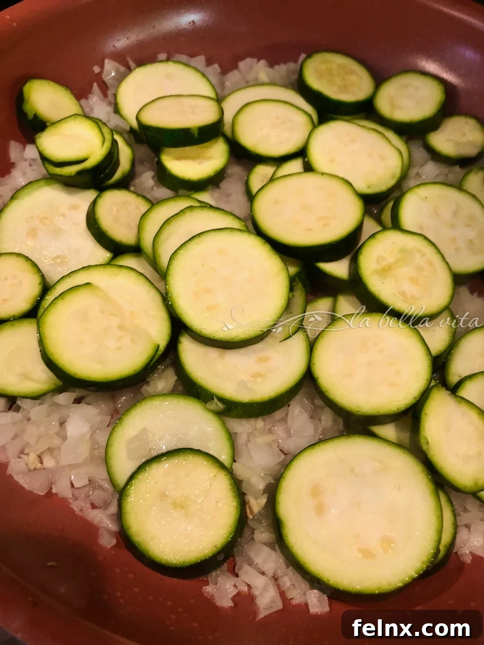 Adding drained zucchini to the pan