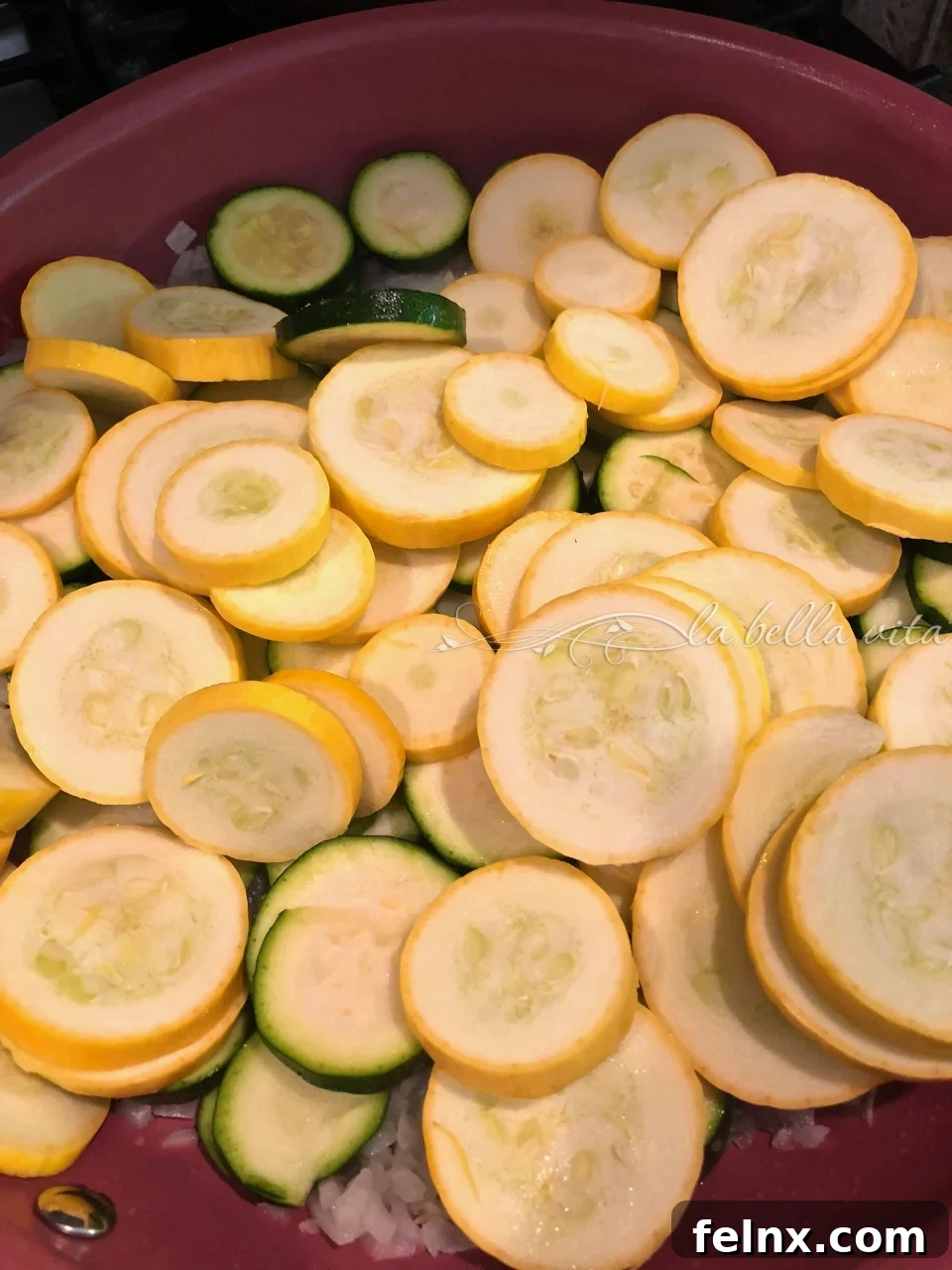 A mix of yellow squash and zucchini in the frying pan