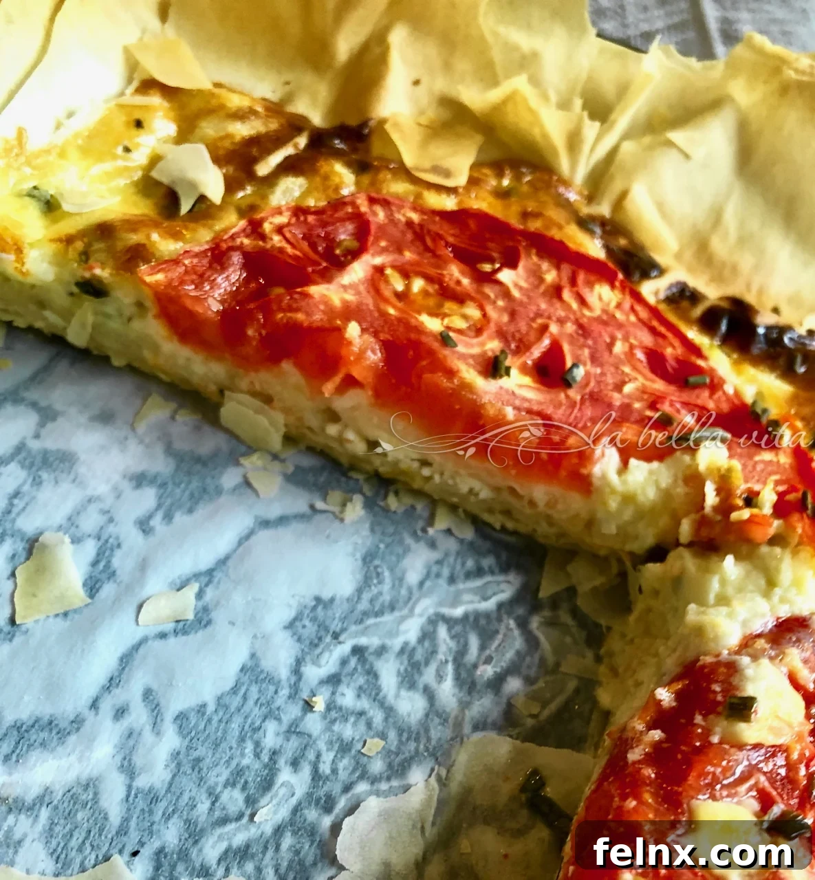 A slice of tomato tart on a plate