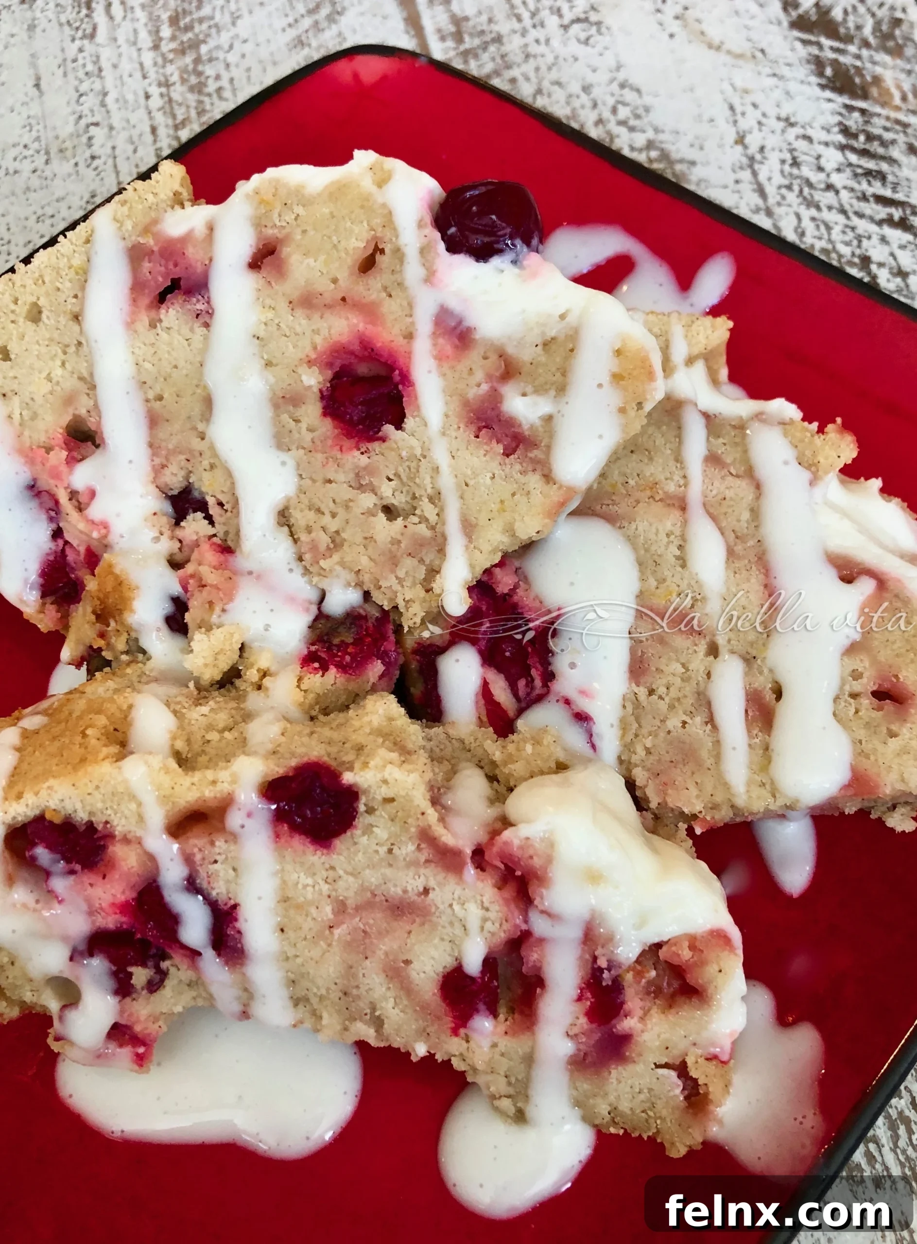 Close up slice of cranberry orange cake with cream cheese icing