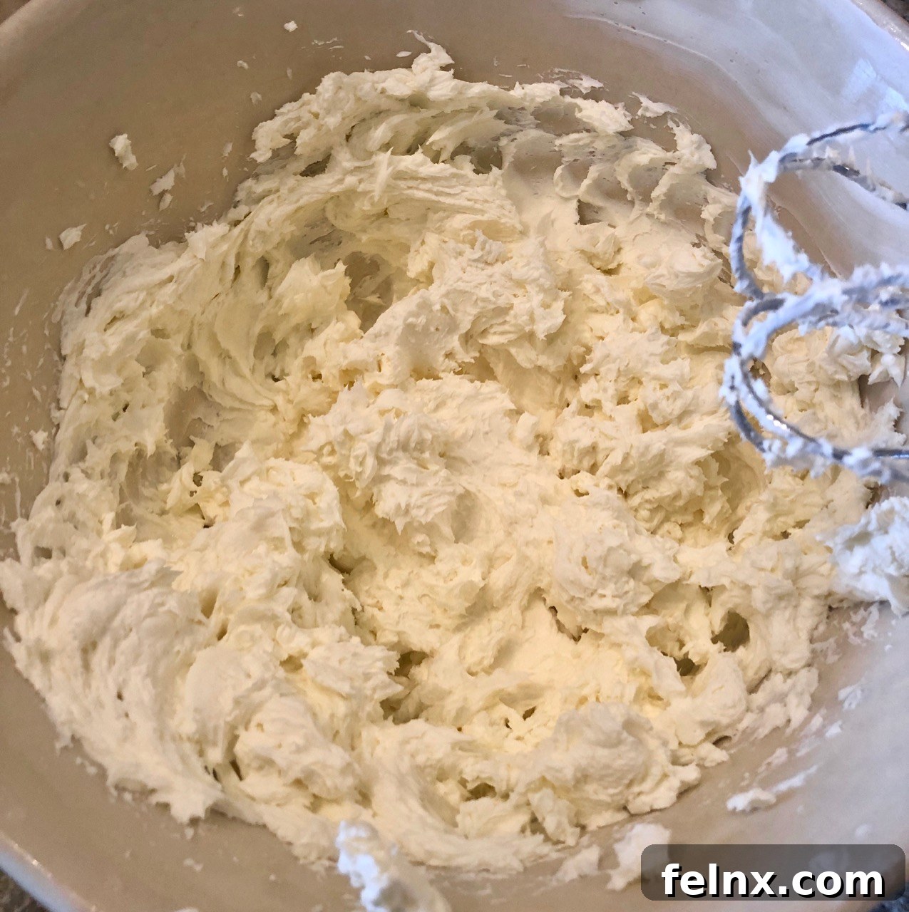 Beating the cream cheese until smooth