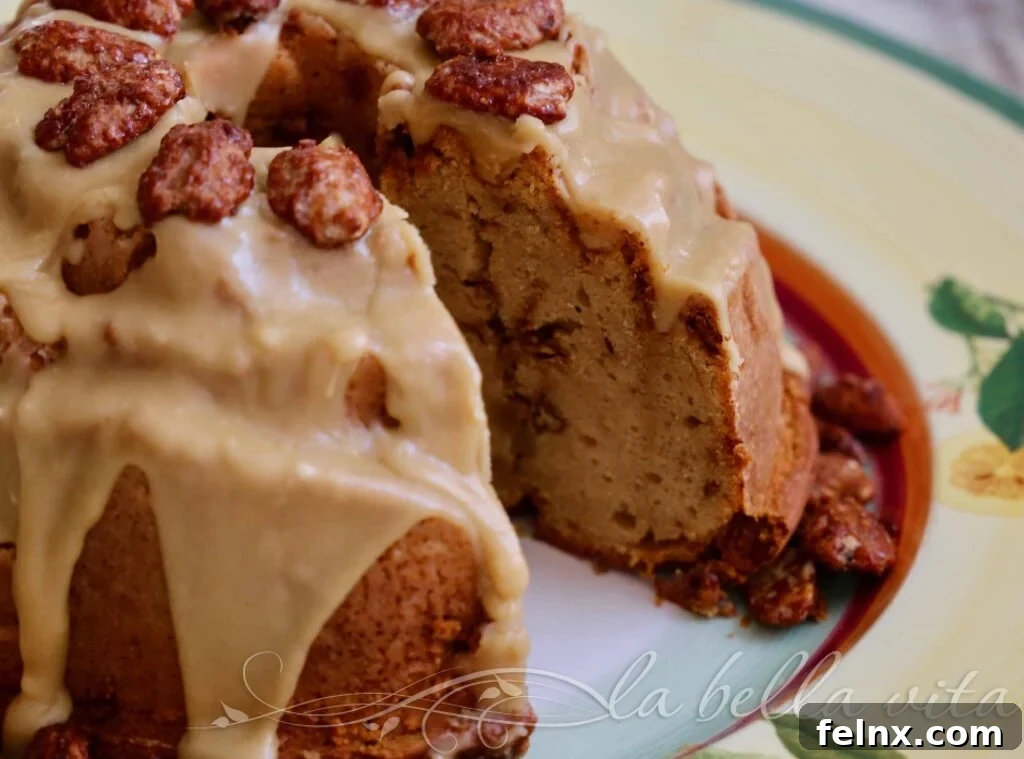 Warm caramel icing being poured over the bundt cake