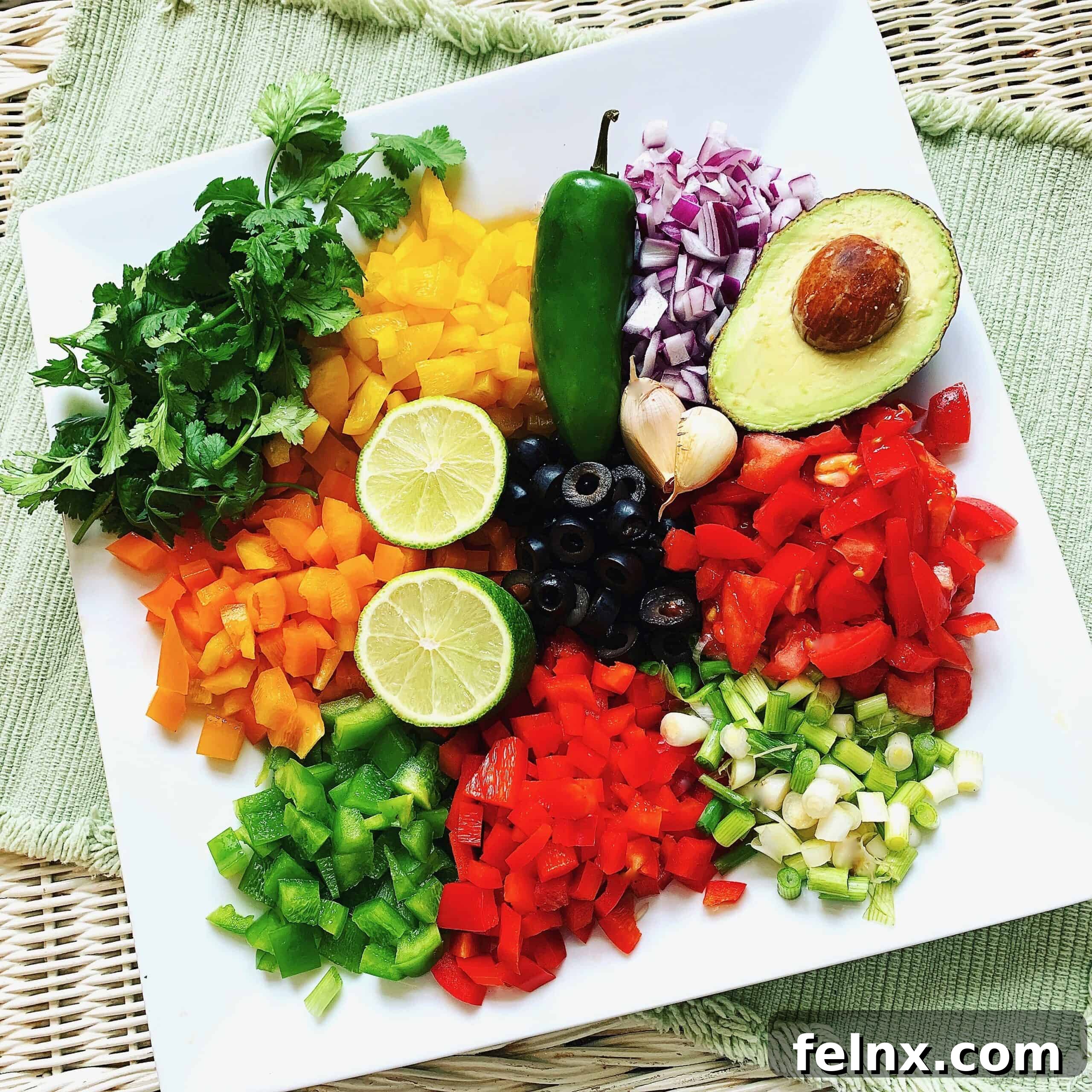 Prepped ingredients for Cowboy Caviar including beans, peppers, and onions