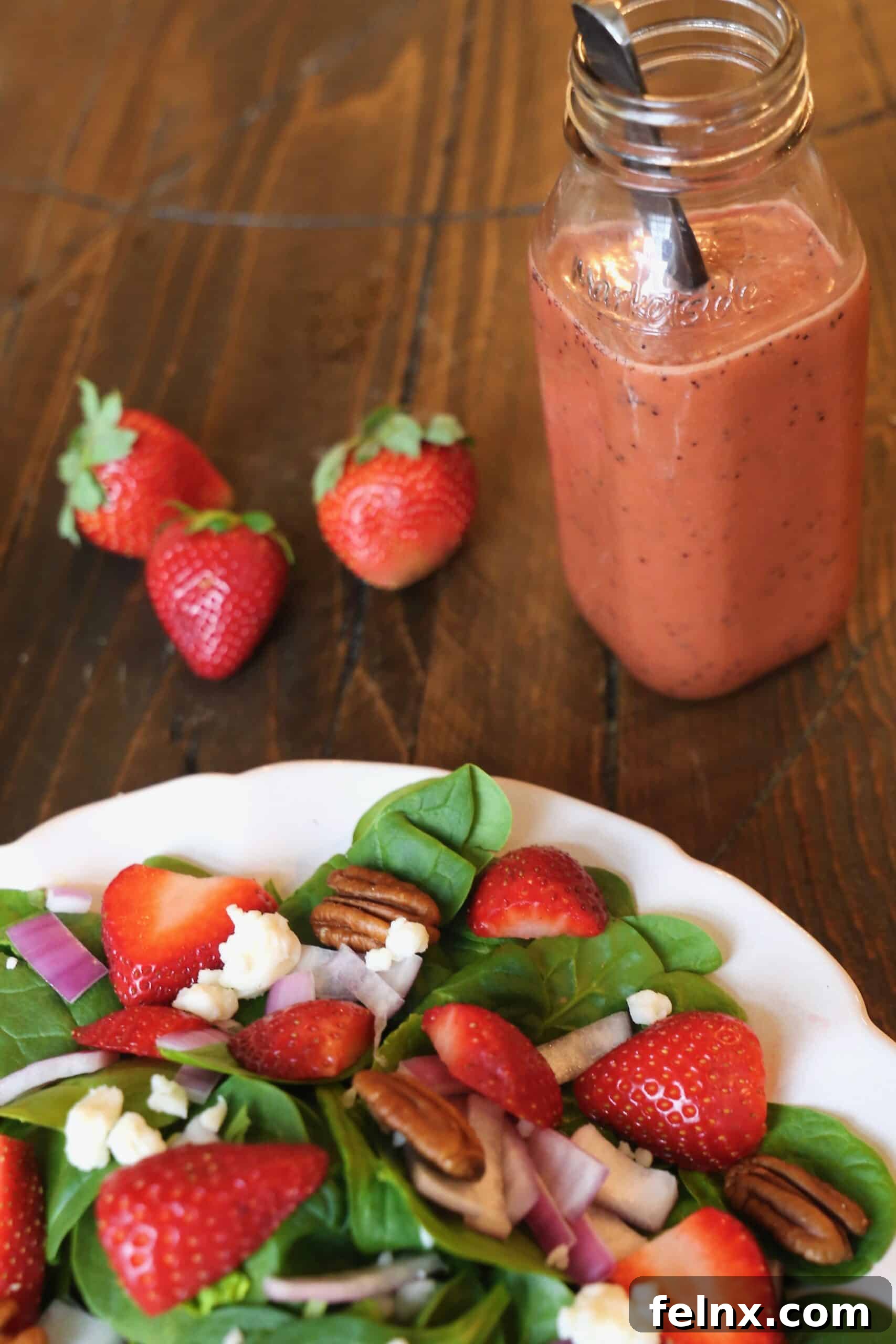 Strawberry Spinach Salad served in a glass bowl