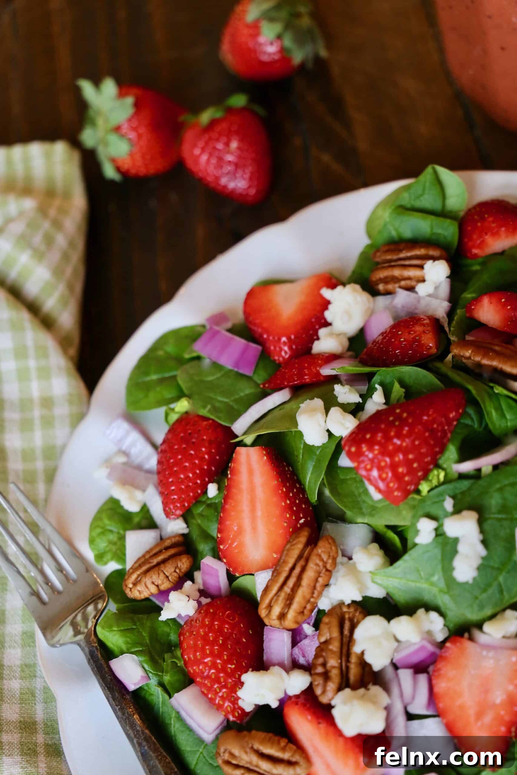 Assembled Strawberry Spinach Salad with walnuts and goat cheese