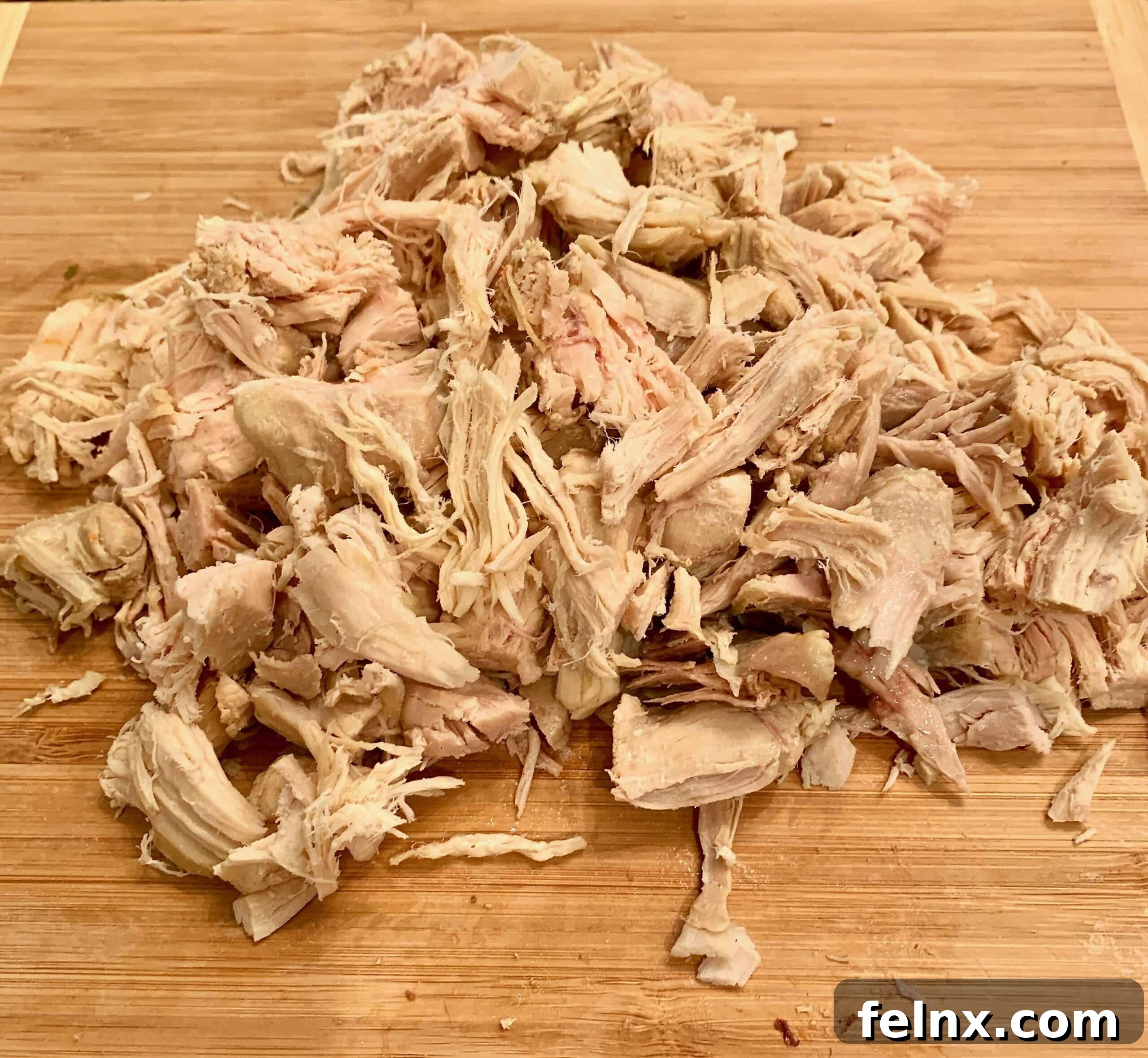 Prepping the cooked chicken for the casserole