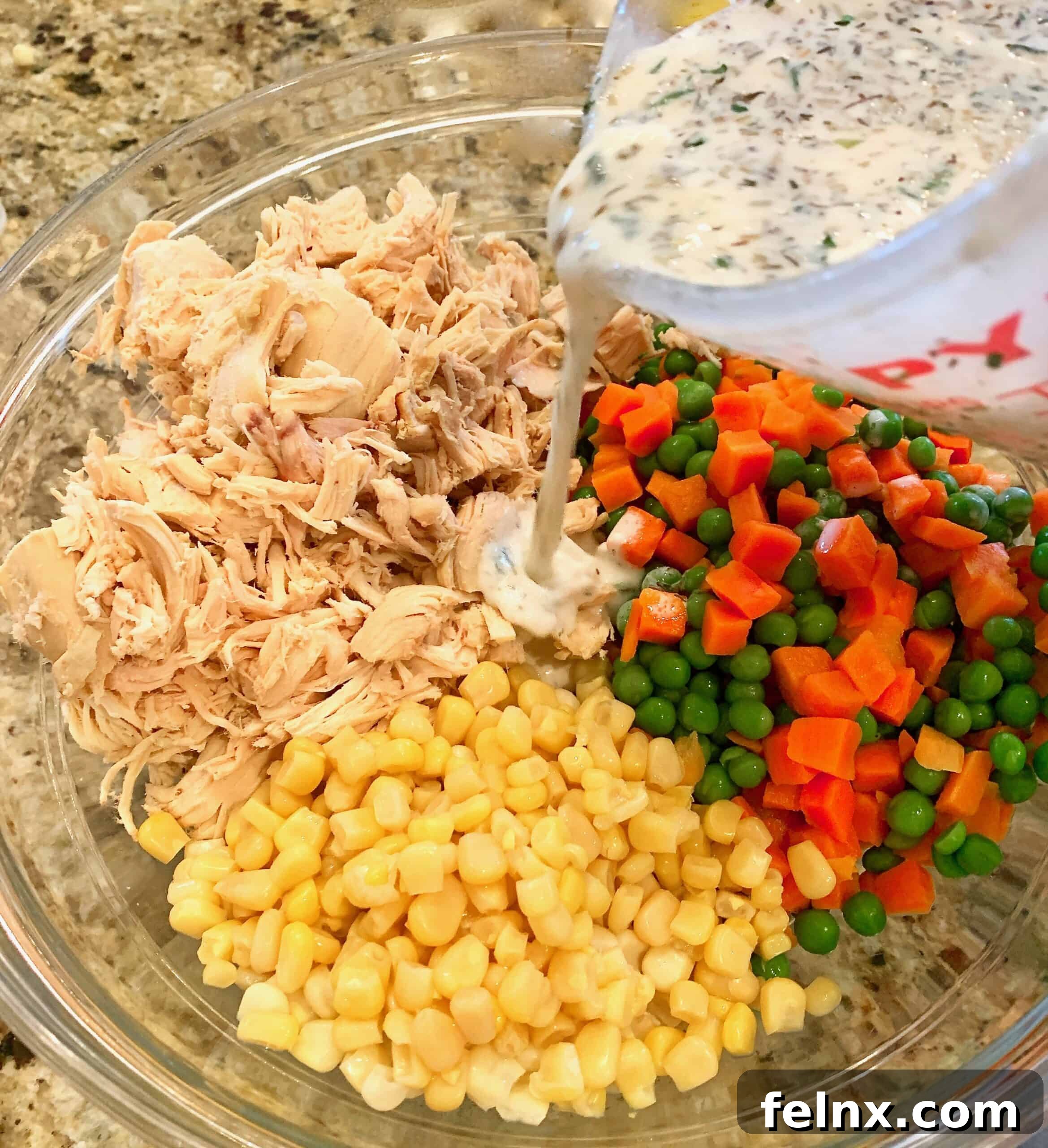Combining sauce with chicken and veggies