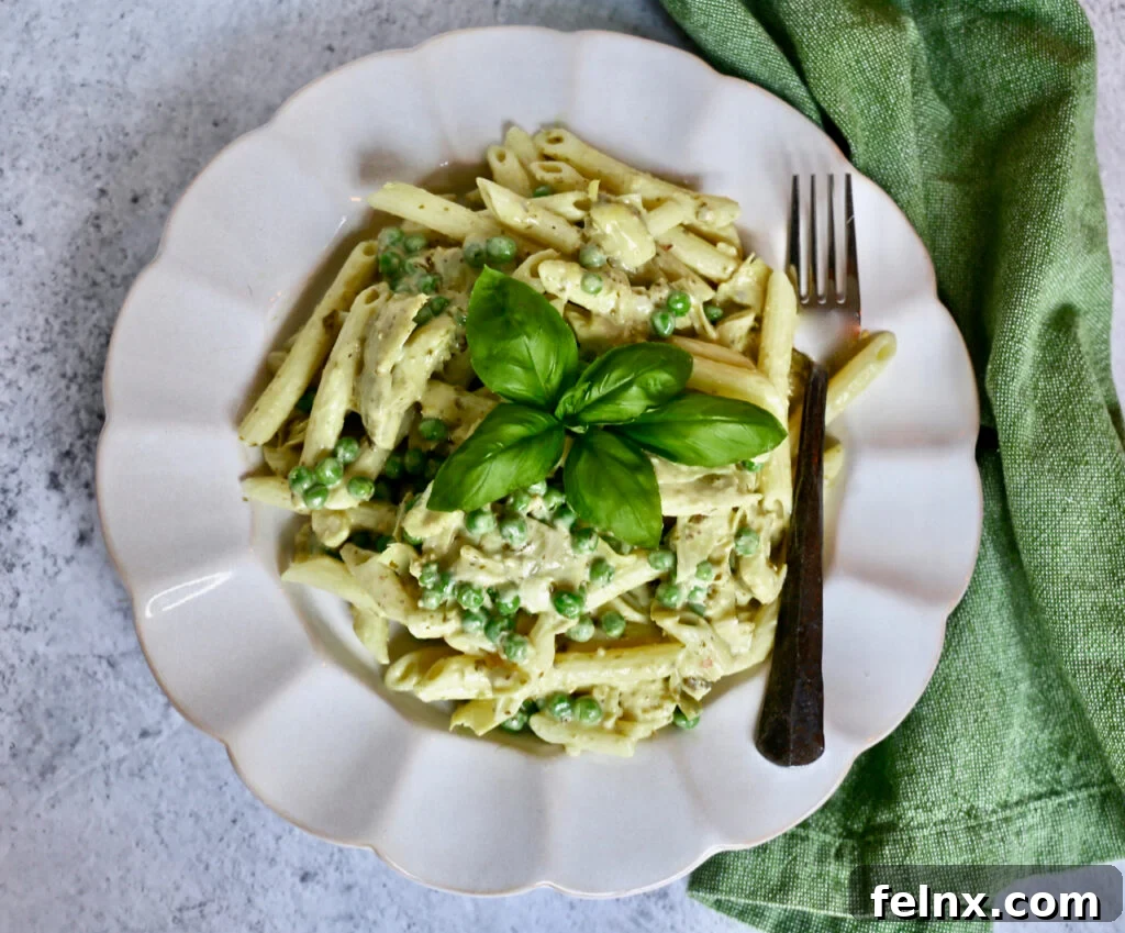 Close-up of Creamy Artichoke and Pesto Pasta Salad with green peas