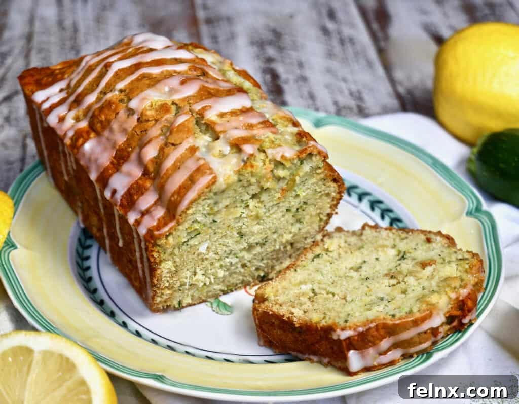 Freshly baked moist lemon zucchini bread on a wooden board