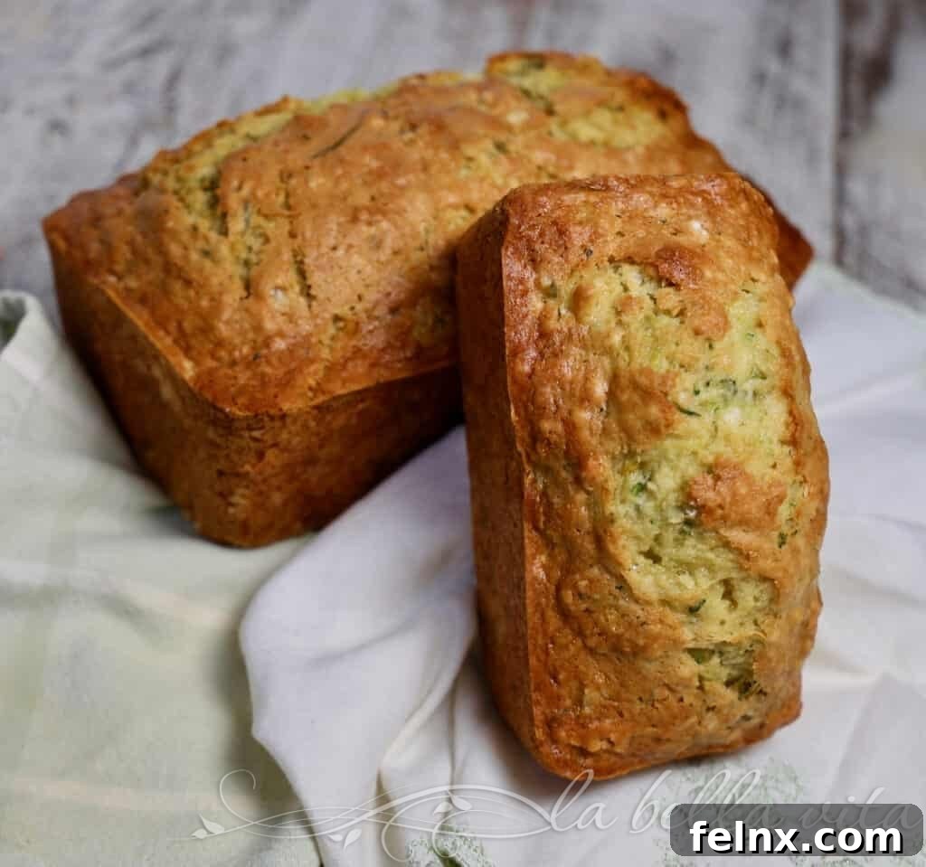 Two loaves of lemon zucchini bread on a cooling rack