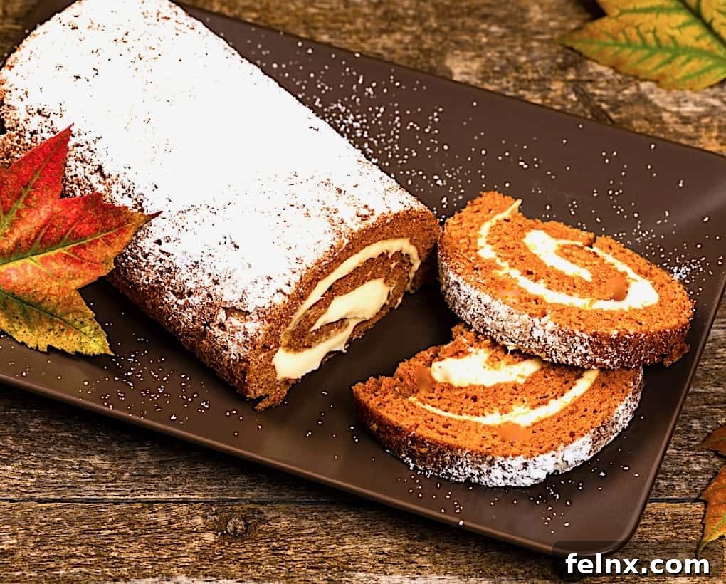 A delicious slice of classic pumpkin roll with cream cheese filling