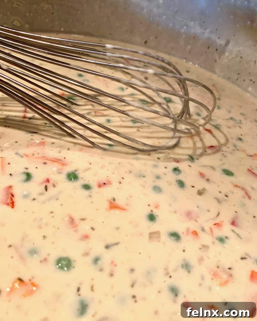 Adding colorful vegetables to the tetrazzini mix