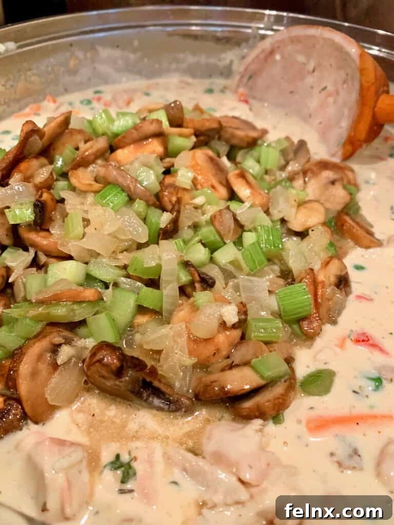 Adding shredded turkey and mushrooms to the sauce