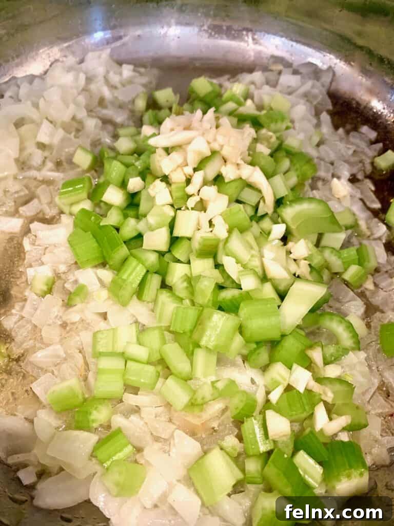 Adding celery and garlic to the skillet