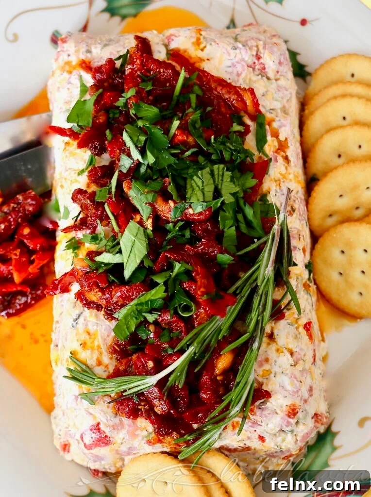Festive Italian Cheese Log decorated with sun-dried tomatoes and rosemary