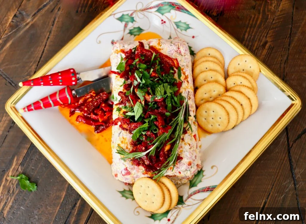 Completed Italian cheese log served with crackers on a platter
