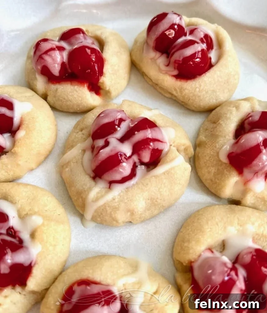 Delicious Cherry Pie Shortbread Thumbprint Cookies with white icing drizzle