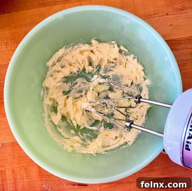 Butter and sugar being creamed together in a bowl