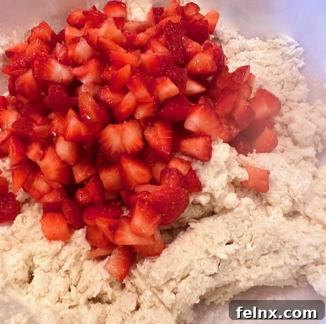 Folding strawberries into the scone dough