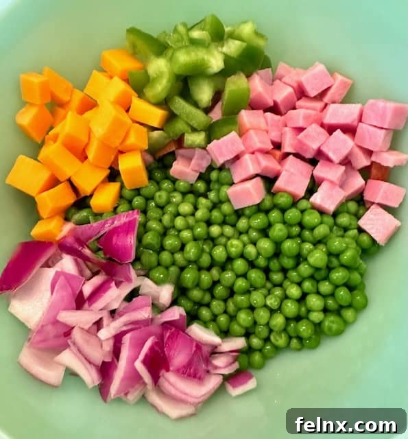 Mixing the pea salad ingredients